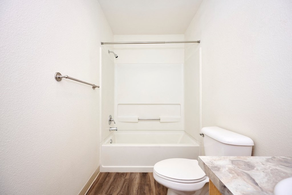 Bathroom with full size tub and plank flooring at Devonwood and First Place Apartments, Battle Ground Washington