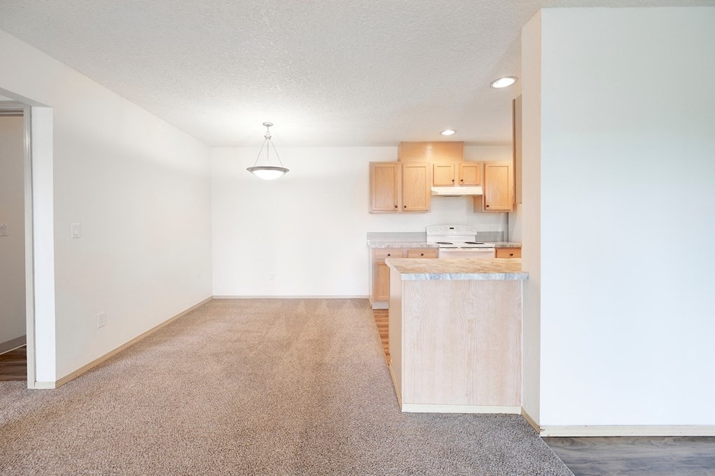 View of dining and kitchen area from living room at Devonwood and First Place Apartments, Battle Ground, WA