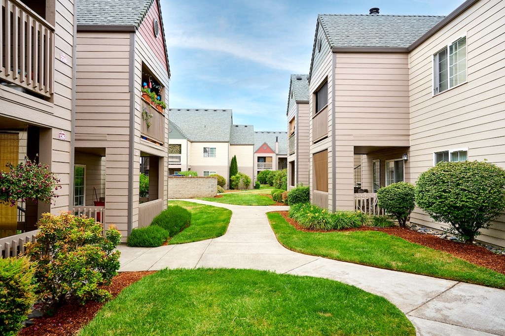 Building exteriors and lush landscaping at Devonwood and First Place Apartments, Battle Ground, WA 98604