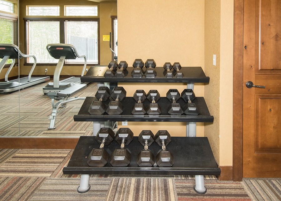 Apartments in South Hill Puyallup - Bella on Canyon - Fitness Center with Carpet, Wall-to-Ceiling Mirror. Free Weights, and Cardio Equipment