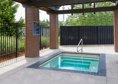 Pet-Friendly Apartments in South Hill Puyallup WA - Bella on Canyon - Sparkling Spa Under Pergola and a Concrete Deck