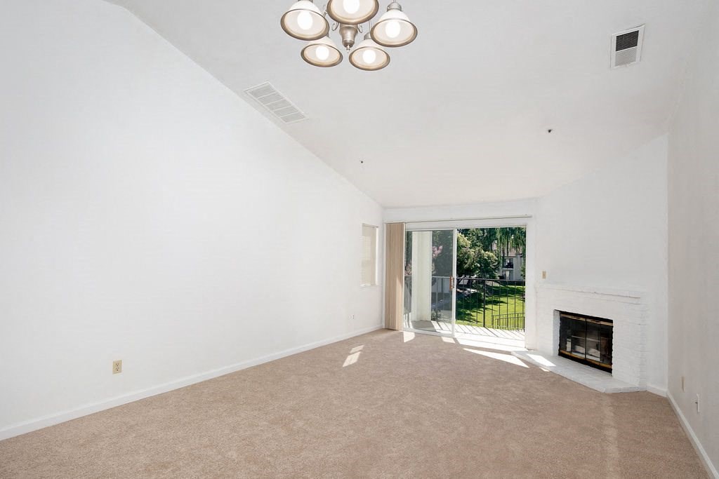 Living Room with High Ceilings, Brick Fireplace, and Private Patio Access at Laurel Creek, Fairfield, 94533