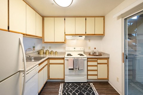 a kitchen with a stove refrigerator and sink