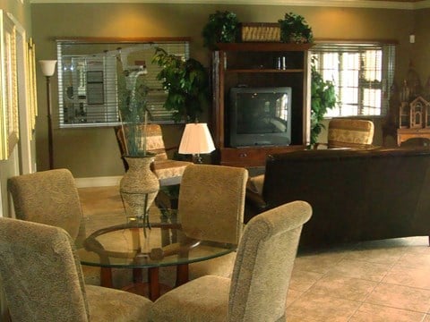 a living room with a table and chairs and a television