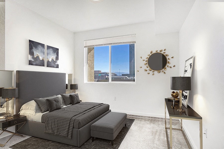 Apartments in Sparks for Rent - The Bridges at Victorian Square - Furnished Bedroom with Large Window and Carpet Flooring