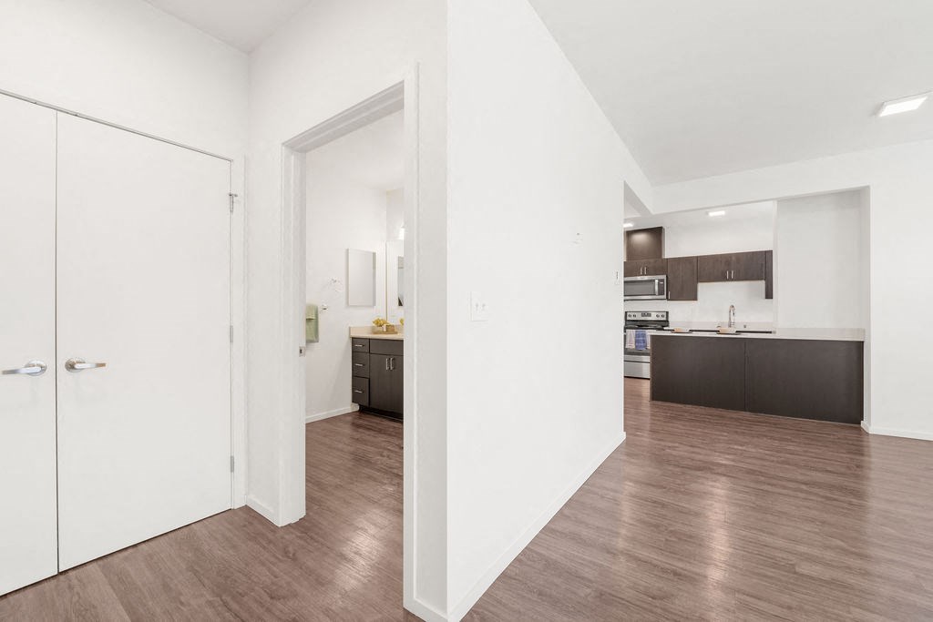 a living room with a medium hardwood floor and white walls