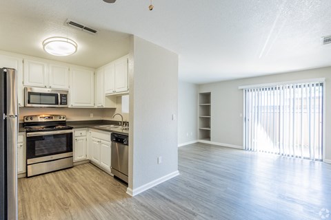 A kitchen with white cabinets and stainless steel appliances.