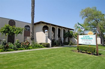 Building exterior with grass and sign - Photo Gallery 2