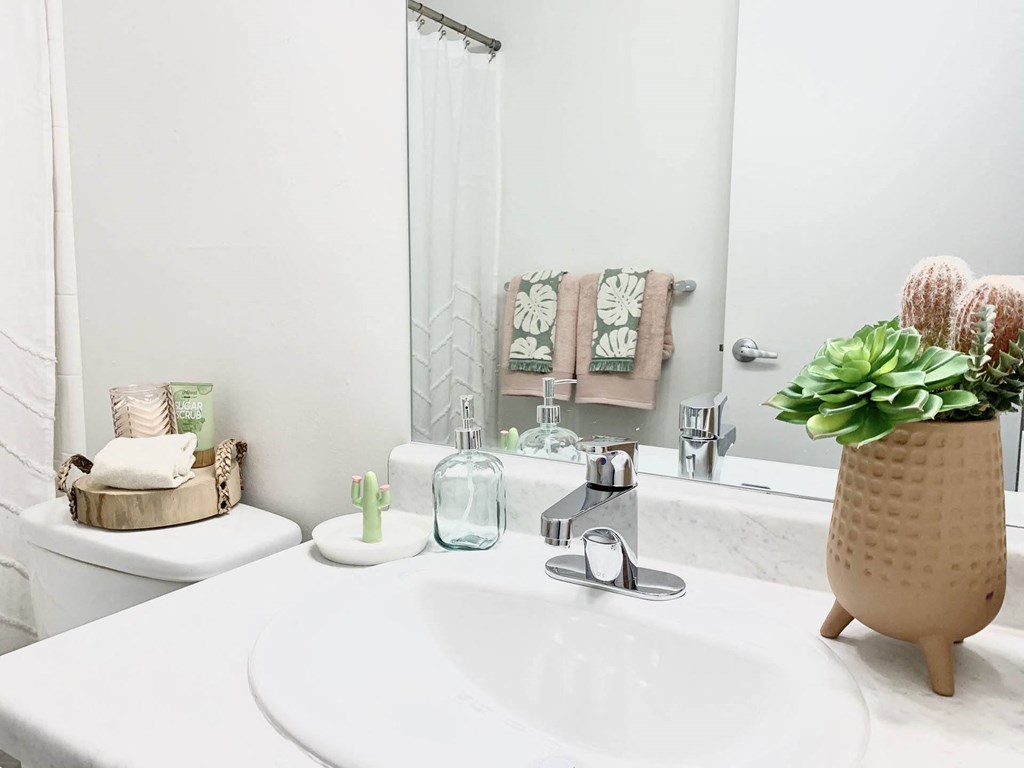 a white bathroom with a sink and a mirror at Cadence Apartments, Utah, 84067