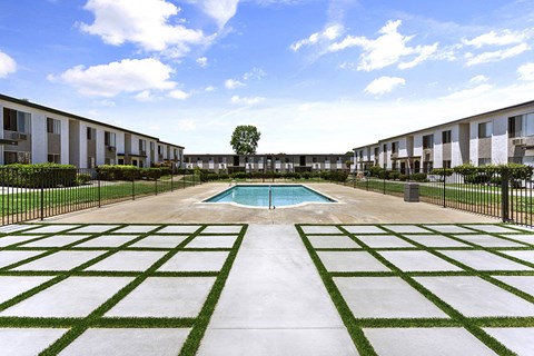 Pool area with decorative grass and pavers 