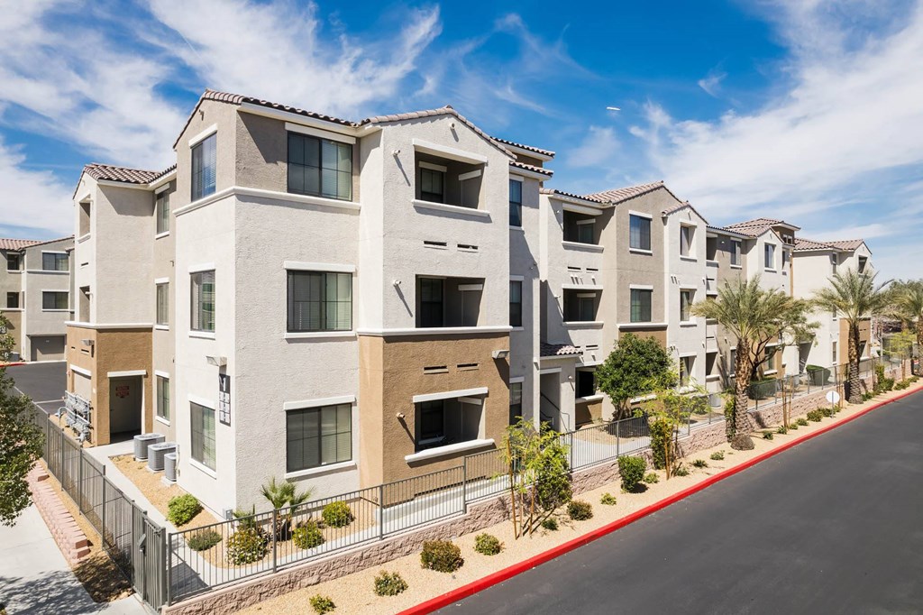 a row of apartment buildings with a street in front of them at CHANDLER APARTMENT HOMES, Las Vegas