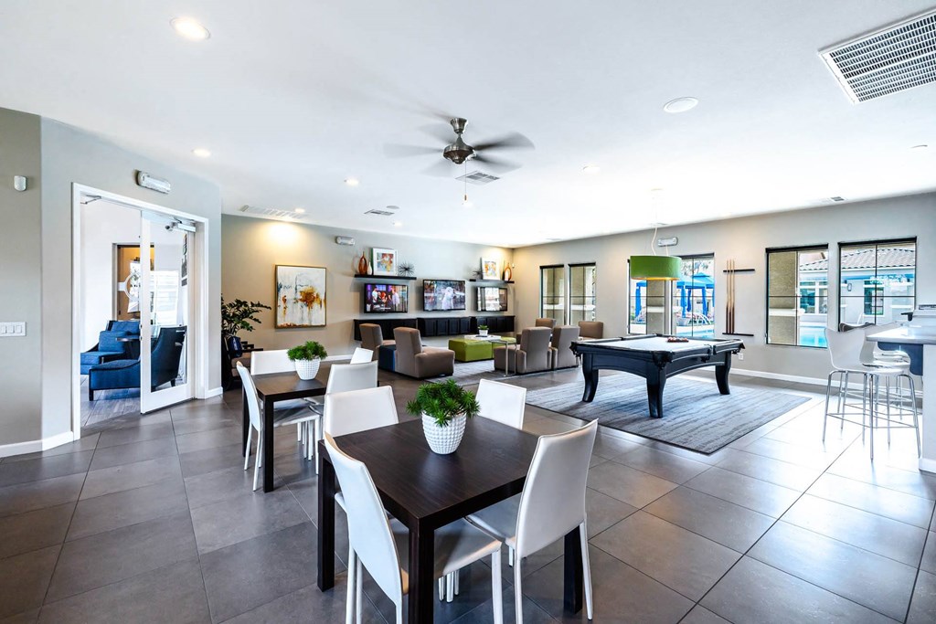 a living room with a table and chairs and a pool at CHANDLER APARTMENT HOMES, Las Vegas, 89139