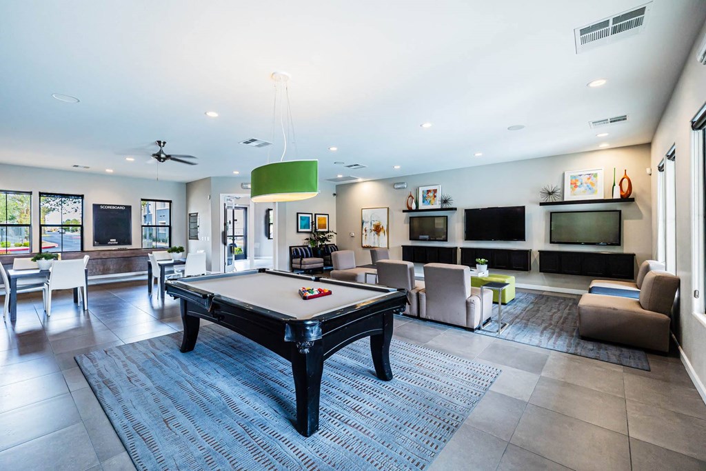 a clubhouse with a pool table and a tv at CHANDLER APARTMENT HOMES, Las Vegas, Nevada