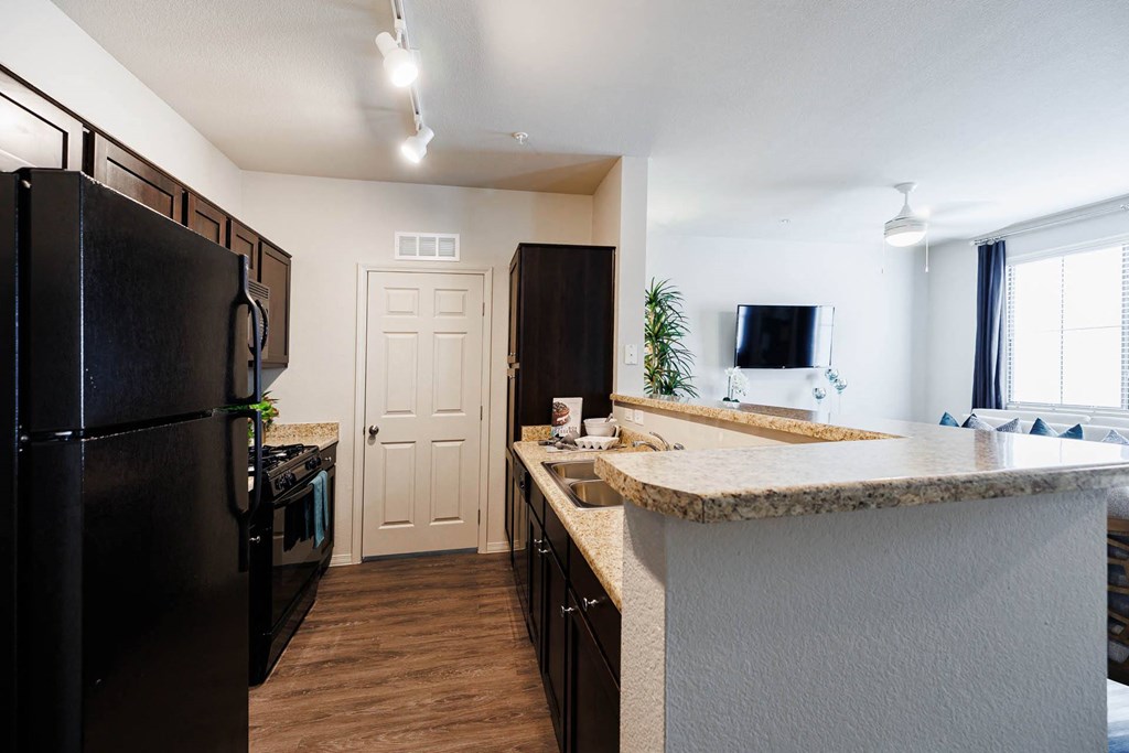 a kitchen with a counter top and a refrigerator at CHANDLER APARTMENT HOMES, Las Vegas, Nevada