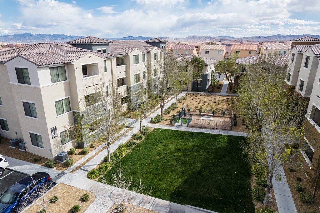 an aerial view of an apartment complex with a yard and green grass at CHANDLER APARTMENT HOMES, Las Vegas, 89139
