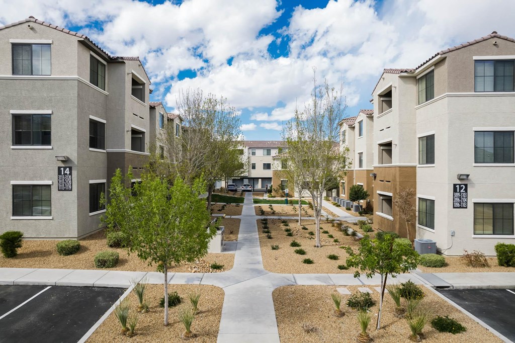 a view of a courtyard between several apartment buildings at CHANDLER APARTMENT HOMES, Las Vegas, NV