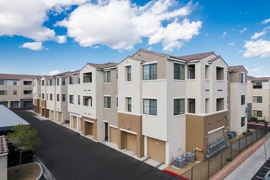 a row of apartment buildings with a street in front of them at CHANDLER APARTMENT HOMES, Las Vegas, 89139