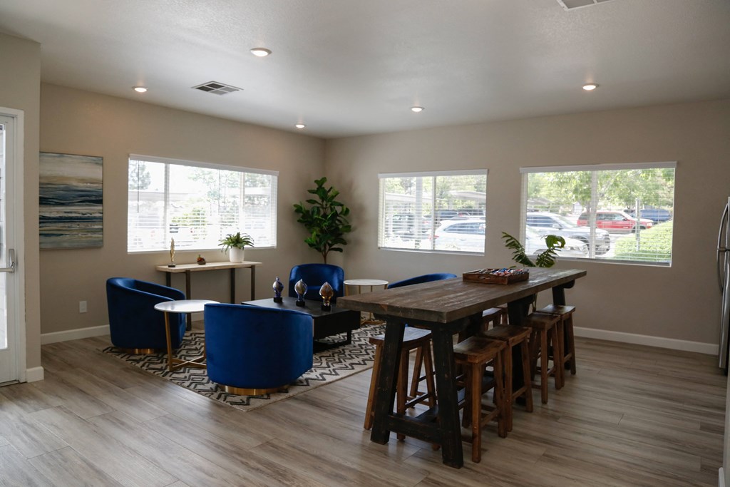 a dining room with a large wooden table and blue chairs