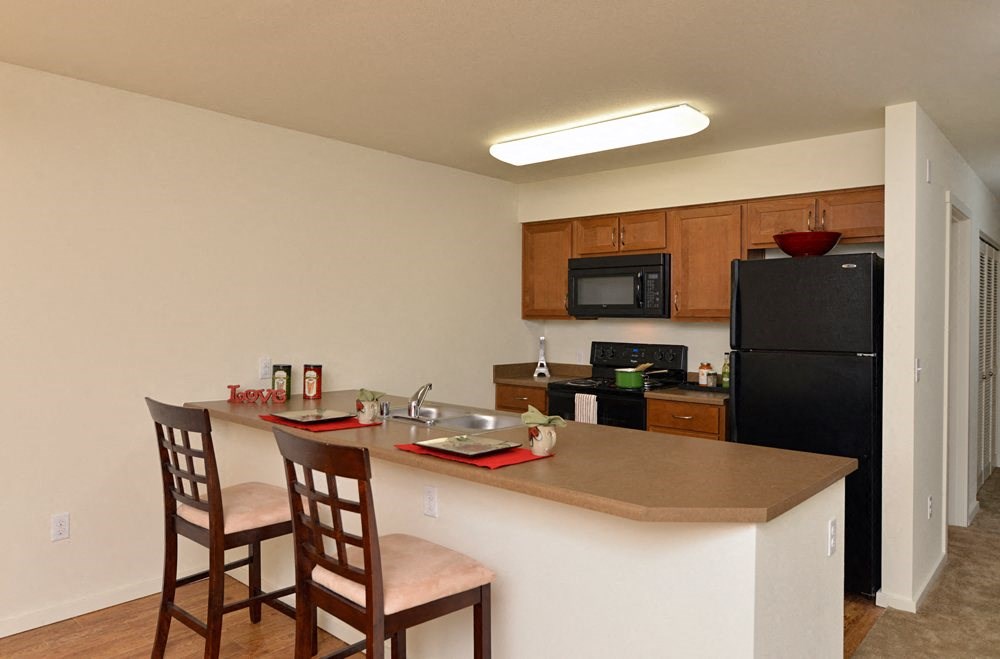 Fully equipped kitchen with black appliances