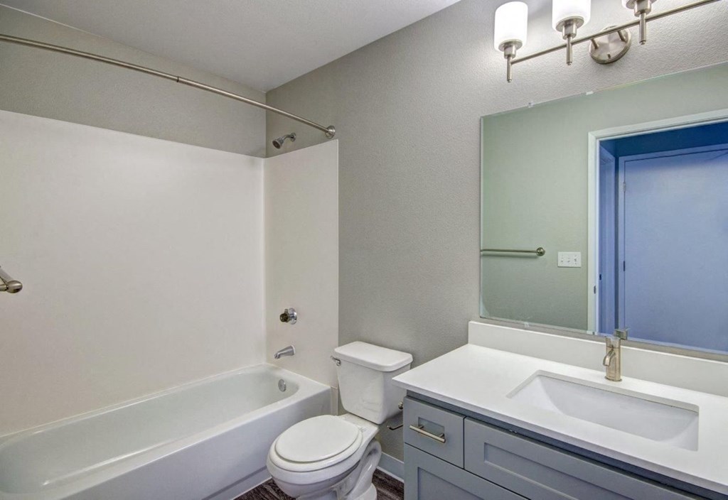 Clock Tower Village bathroom with tub and vanity