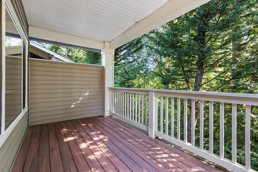 One Bedroom Apartments in Olympia WA  - Yauger Park Villas - Private Balcony with White Railing, Wood Flooring, and Forest Views