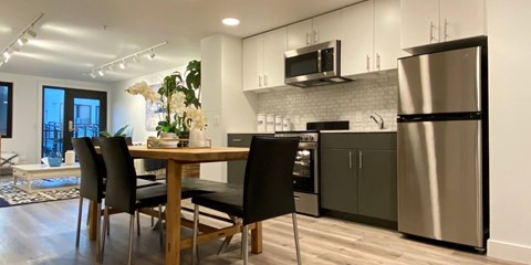 A modern kitchen with a dining table and chairs.