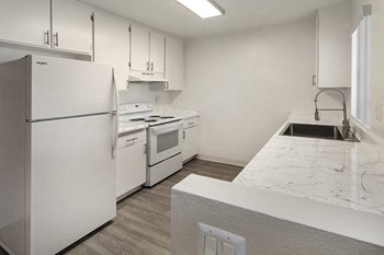 Kitchen with appliances and wood floors - Photo Gallery 2