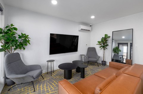 a living room with a couch chairs and a tv on the wall at DOCK 59 APARTMENTS, PORTLAND, Oregon