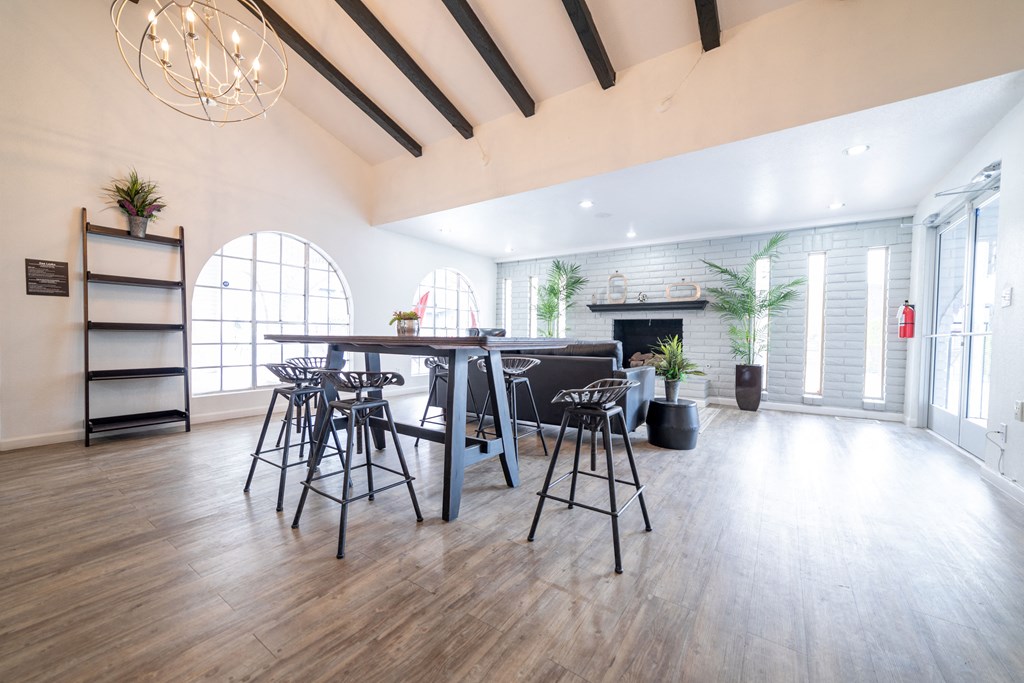 a large room with a large table and chairs and a fireplace in the background at DESERT PEAKS, EL PASO Texas
