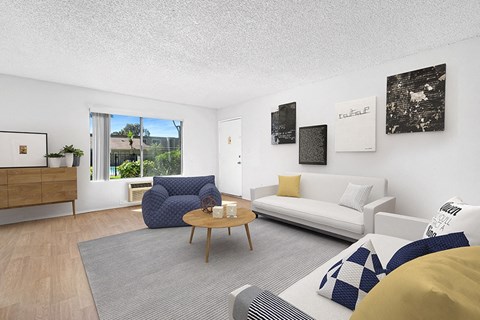 A living room with a blue chair and a white couch.
