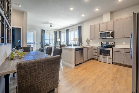 A modern kitchen with a dining table and chairs.