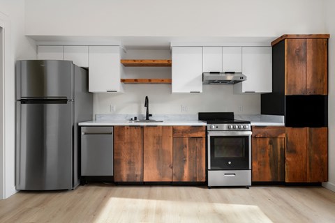 A modern kitchen with wooden cabinets and stainless steel appliances.