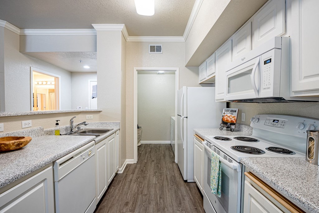 a kitchen with white cabinets and white appliances