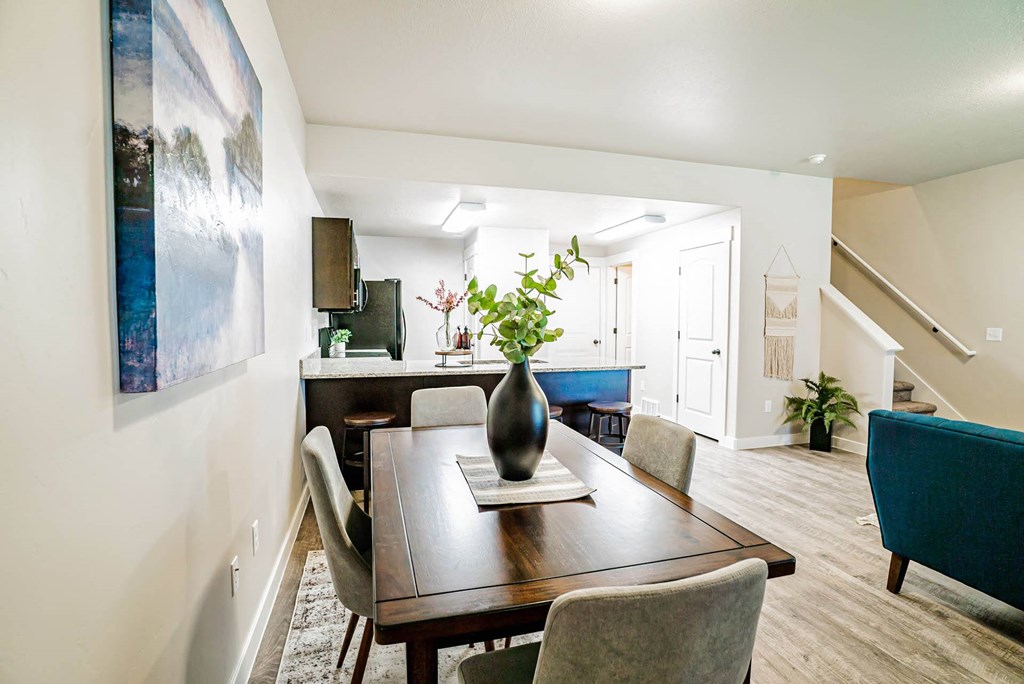 a dining room with a table and chairs at Arcadia Townhomes, Roy Utah
