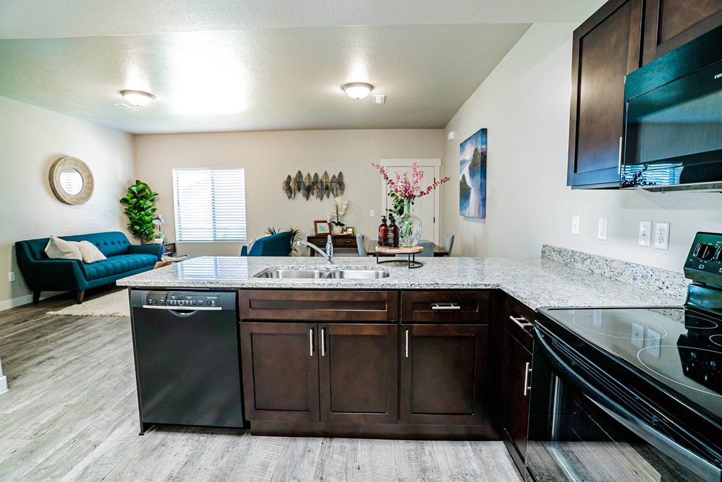 a kitchen with a counter top and a sink at Arcadia Townhomes, Roy Utah