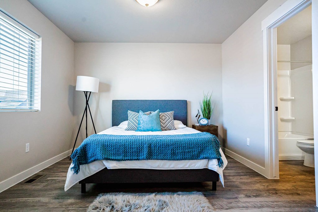 a bedroom with a bed and a closet a bedroom with a bed and a closet at Arcadia Townhomes, Roy, UT