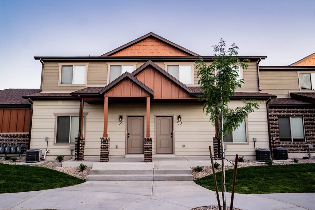 a house with a sidewalk in front of it at Arcadia Townhomes, Utah