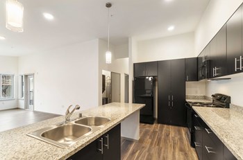 Crescent Point kitchen area with lots of counter space and dark cabinetry - Photo Gallery 3