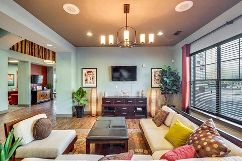 A living room with a white couch and a wooden coffee table.