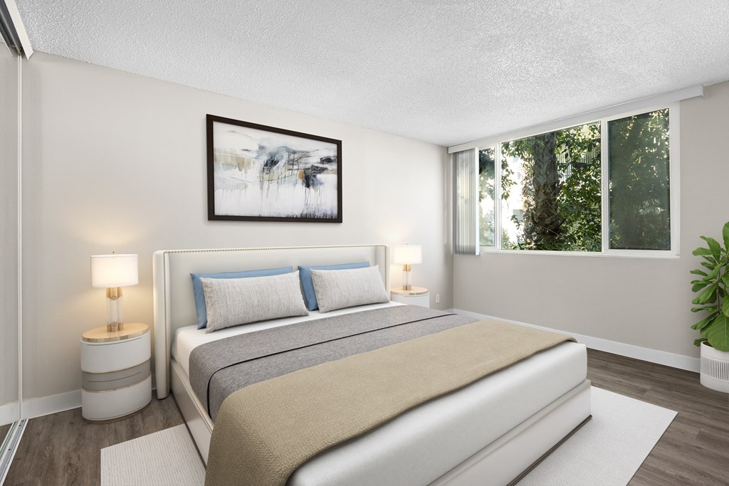 a bedroom with a bed and a large window