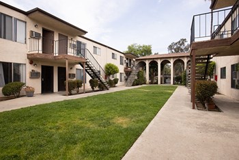Exterior view of apartment buildings with grass - Photo Gallery 3