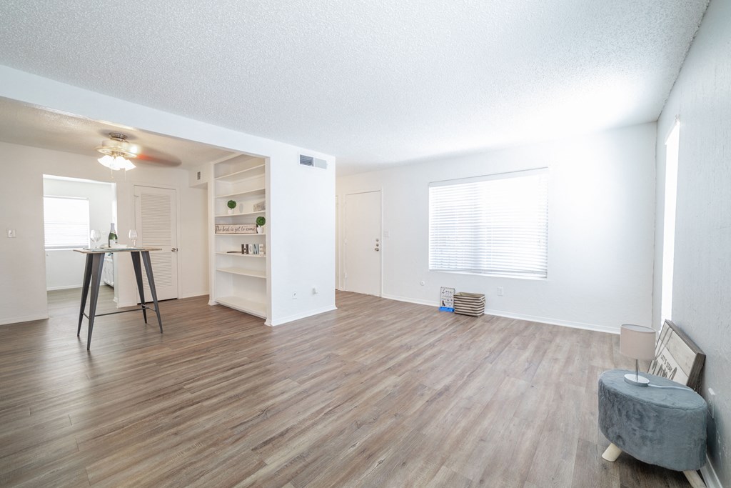 a living room with hardwood floors and white walls at DESERT PEAKS, Texas