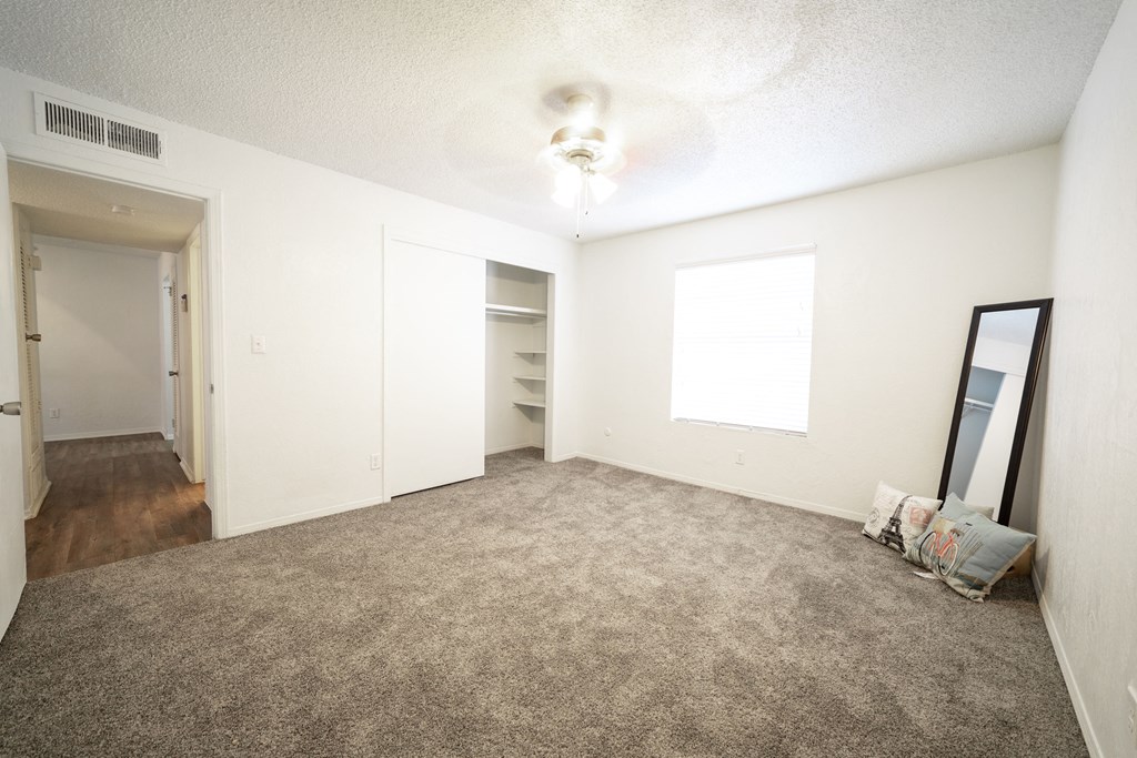a bedroom with carpeted floors and white walls at DESERT PEAKS, EL PASO, 79912