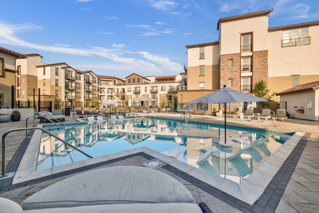 A large swimming pool surrounded by apartment buildings.