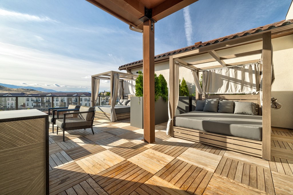A wooden deck with a couch and a table.