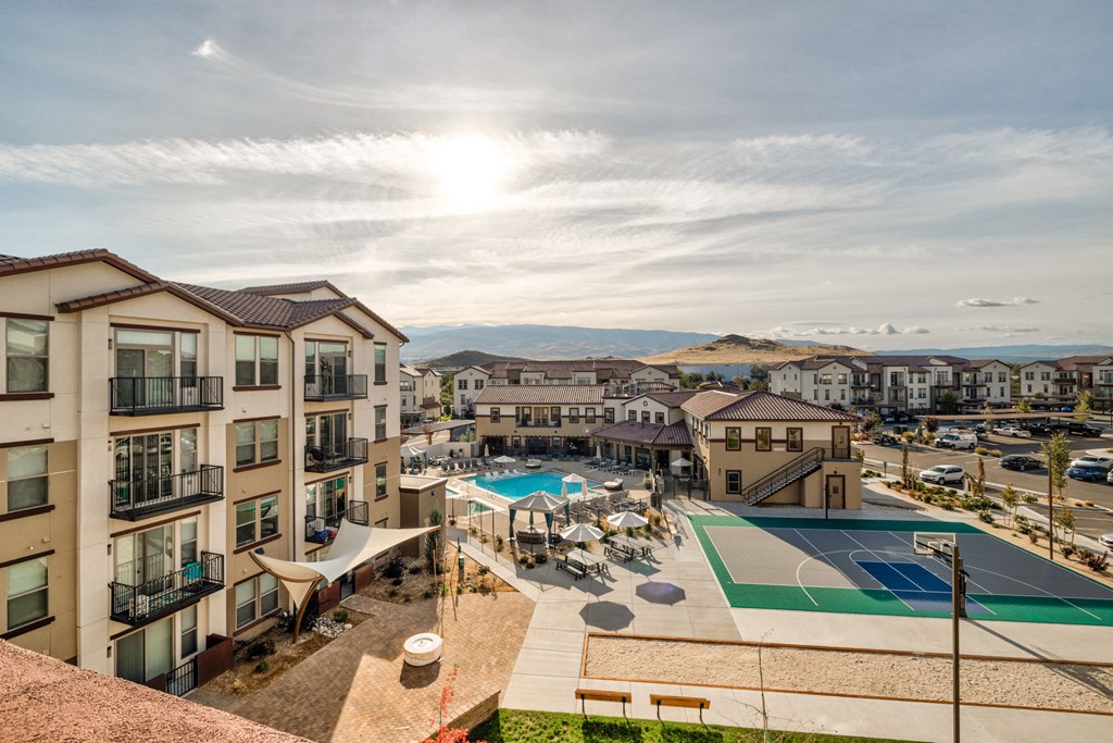 A sunny day at a residential complex with a basketball court and pool.