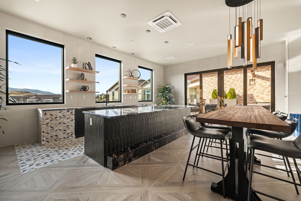 A modern kitchen with a dining table and chairs.
