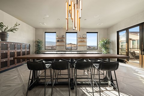 A modern dining room with a long table and chairs.