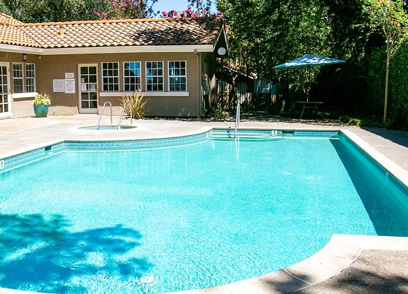 Refreshing pool with seating and unbrellas