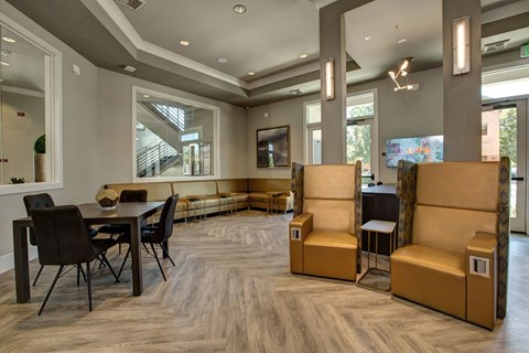 A modern living room with a dining table and chairs.